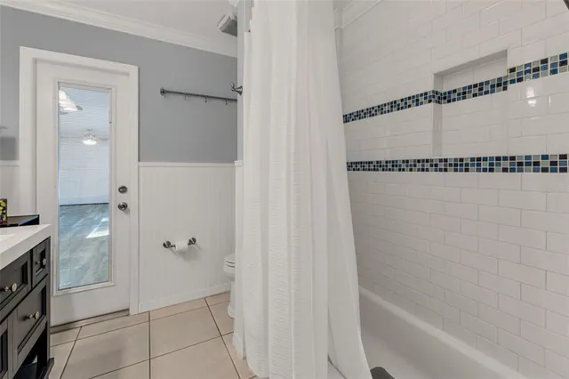 a view of a yard with a house and a large tree