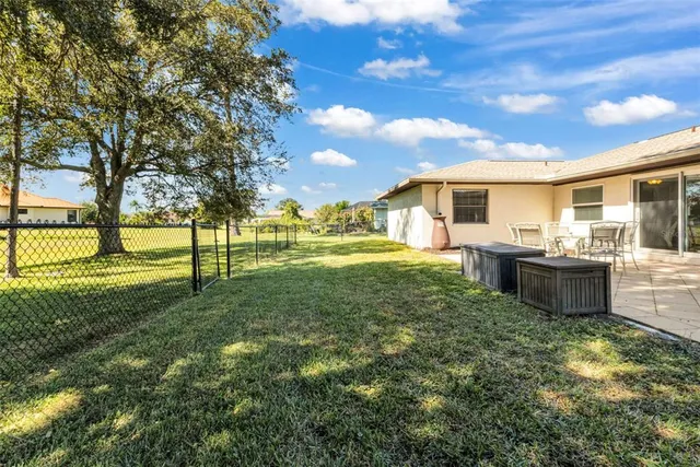 a view of a house with a large window and yard