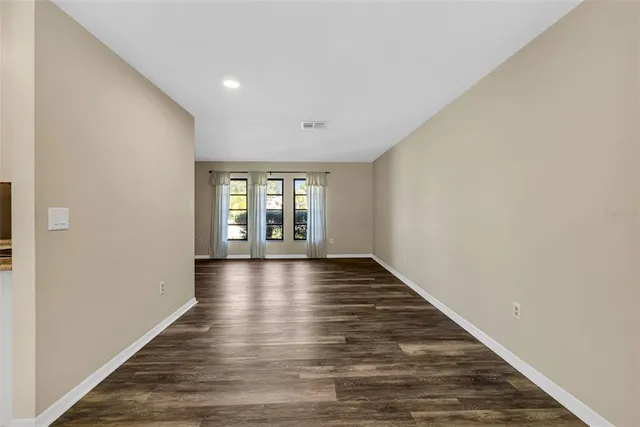 a kitchen with stainless steel appliances kitchen island granite countertop a refrigerator and a stove top oven