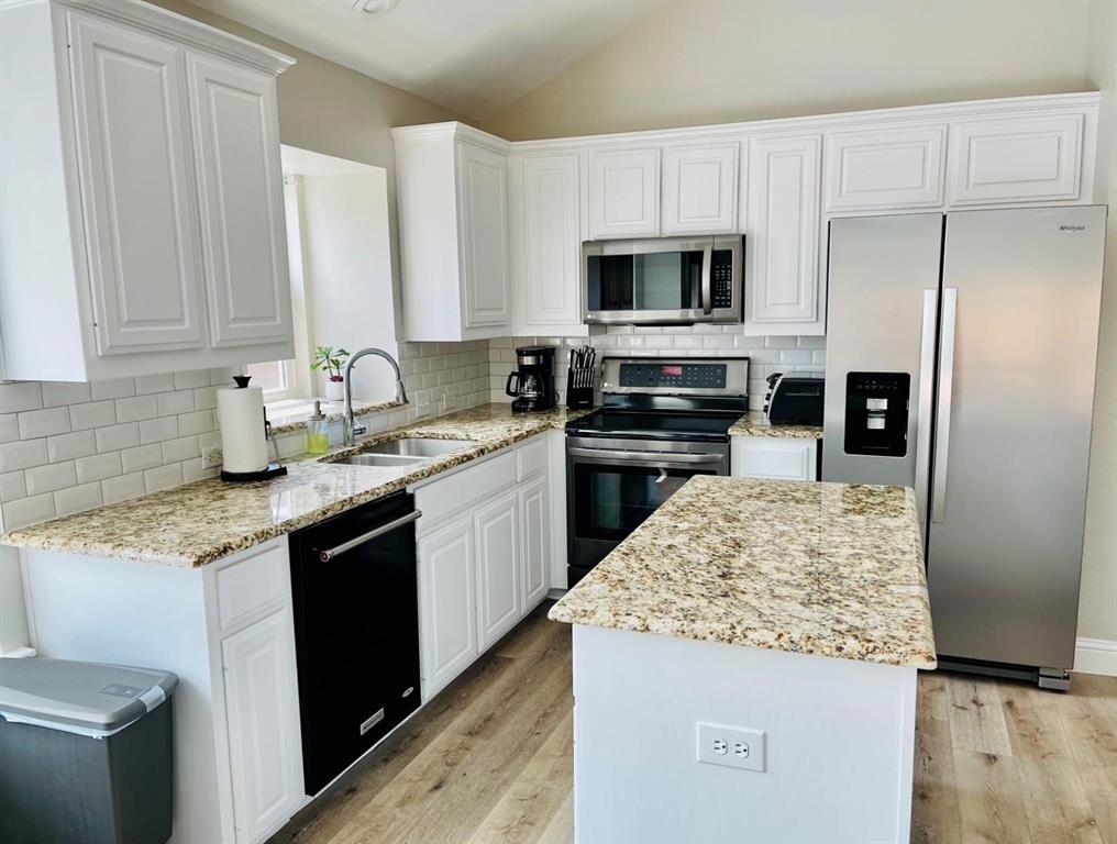 7848 Lancelot Road Frisco, TX 75035 - Photo 11 of 27 a kitchen with stainless steel appliances granite countertop a sink stove and refrigerator