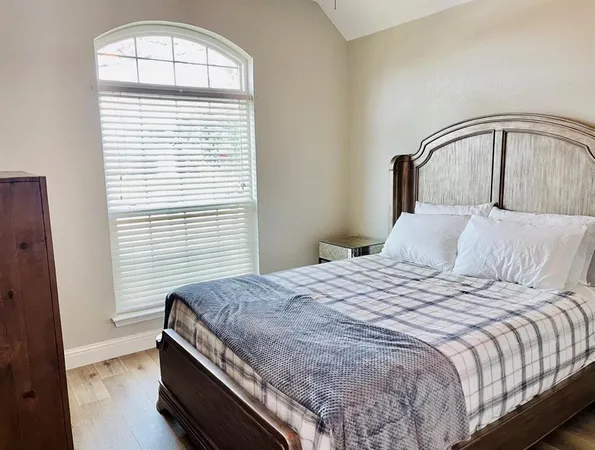 a bedroom with a bed and a window