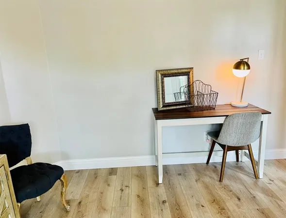 a workspace with furniture and window