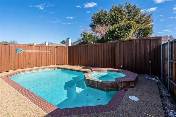 a backyard of a house with yard table and chairs