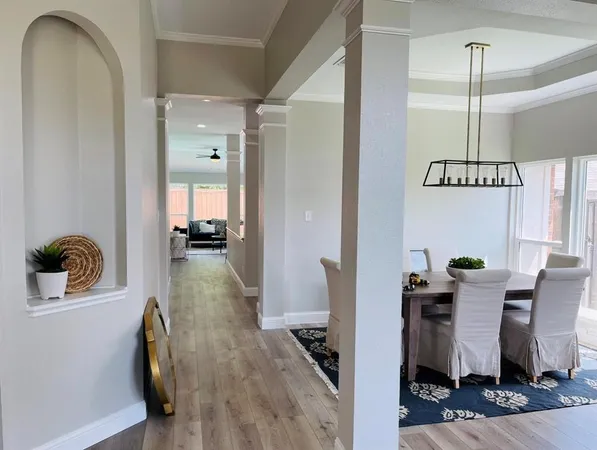 a dining room with furniture and wooden floor