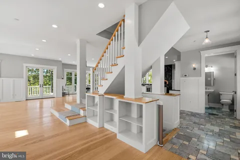 a dining room with furniture and large windows