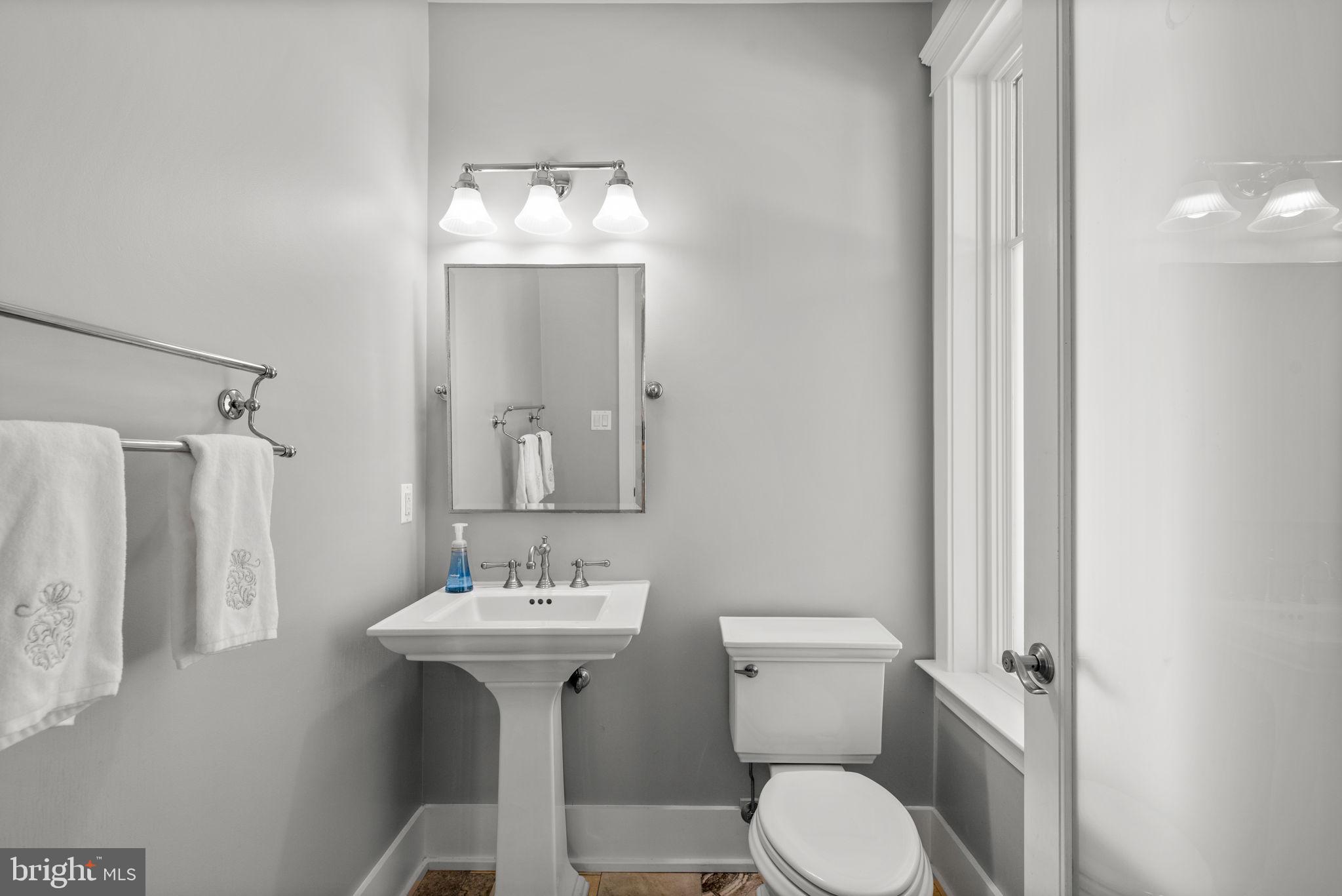 3216 Ramsland Way Frederick, MD 21704 - Photo 13 of 90 a bathroom with a toilet sink and mirror