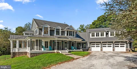 a front view of a house with a yard table and chairs