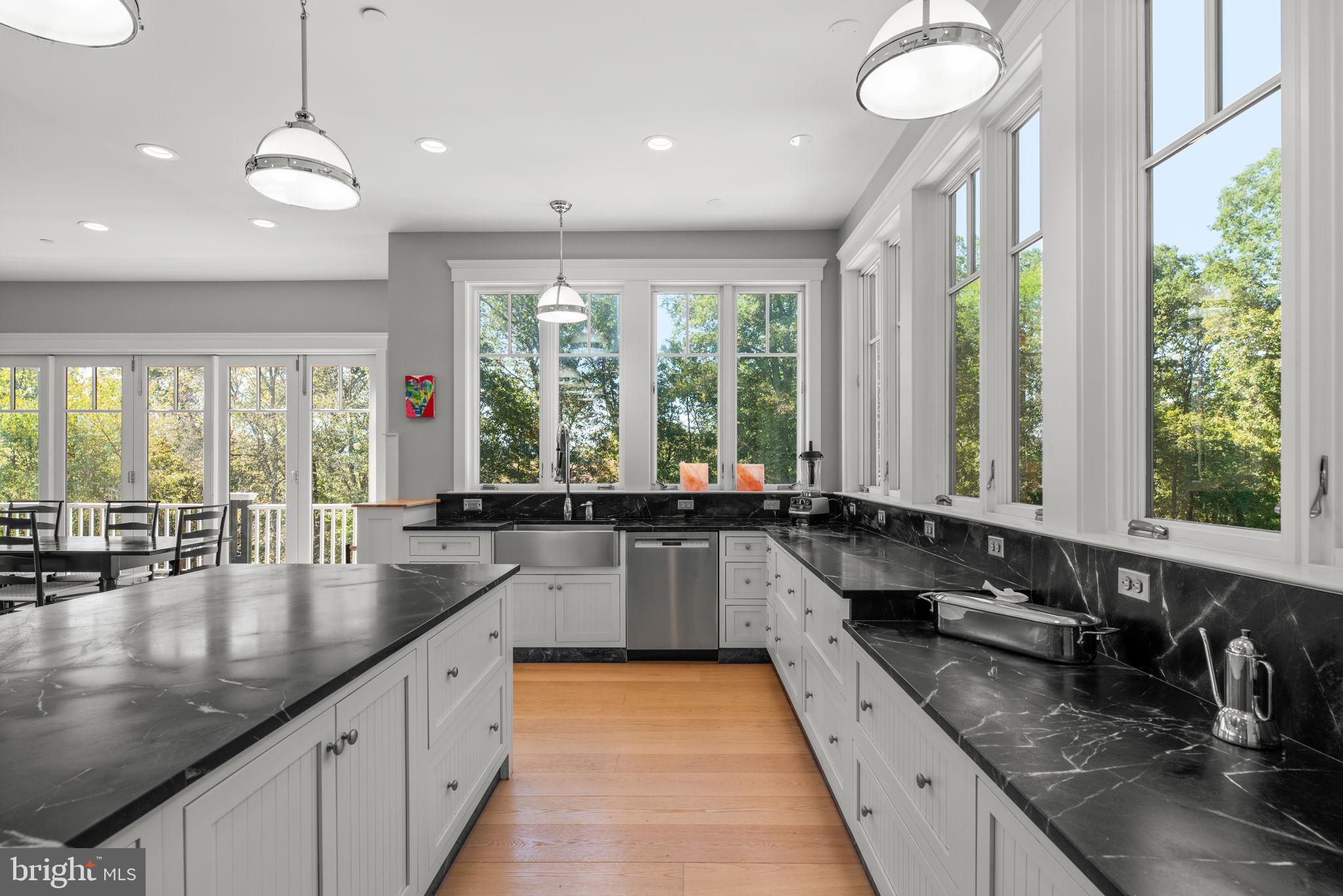3216 Ramsland Way Frederick, MD 21704 - Photo 25 of 90 a large kitchen with lots of counter space large windows and a chandelier