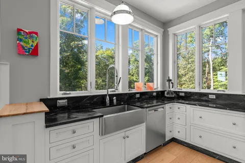 a bathroom with a sink mirror and toilet