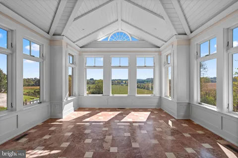 a bedroom with a large bed and a large window