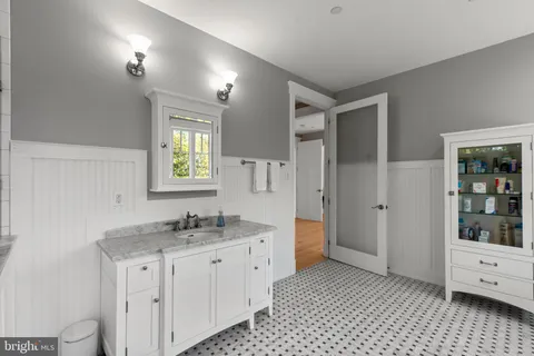 an aerial view of a house with a garden and lake view