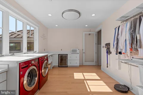 an aerial view of a house with a garden and lake view