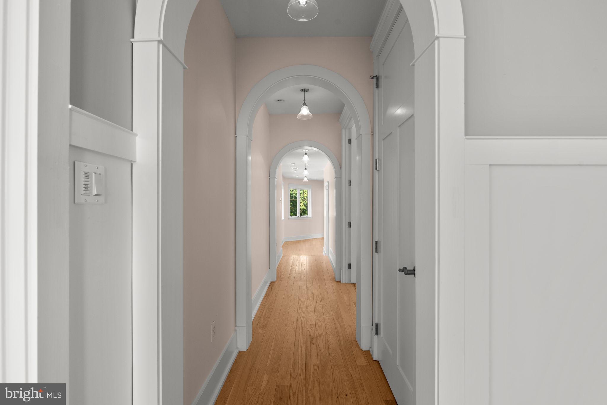 3216 Ramsland Way Frederick, MD 21704 - Photo 50 of 90 a view of a hallway with wooden floor and staircase