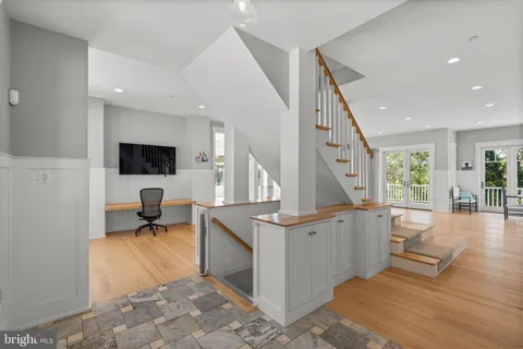 a view of an entryway with wooden floor and windows