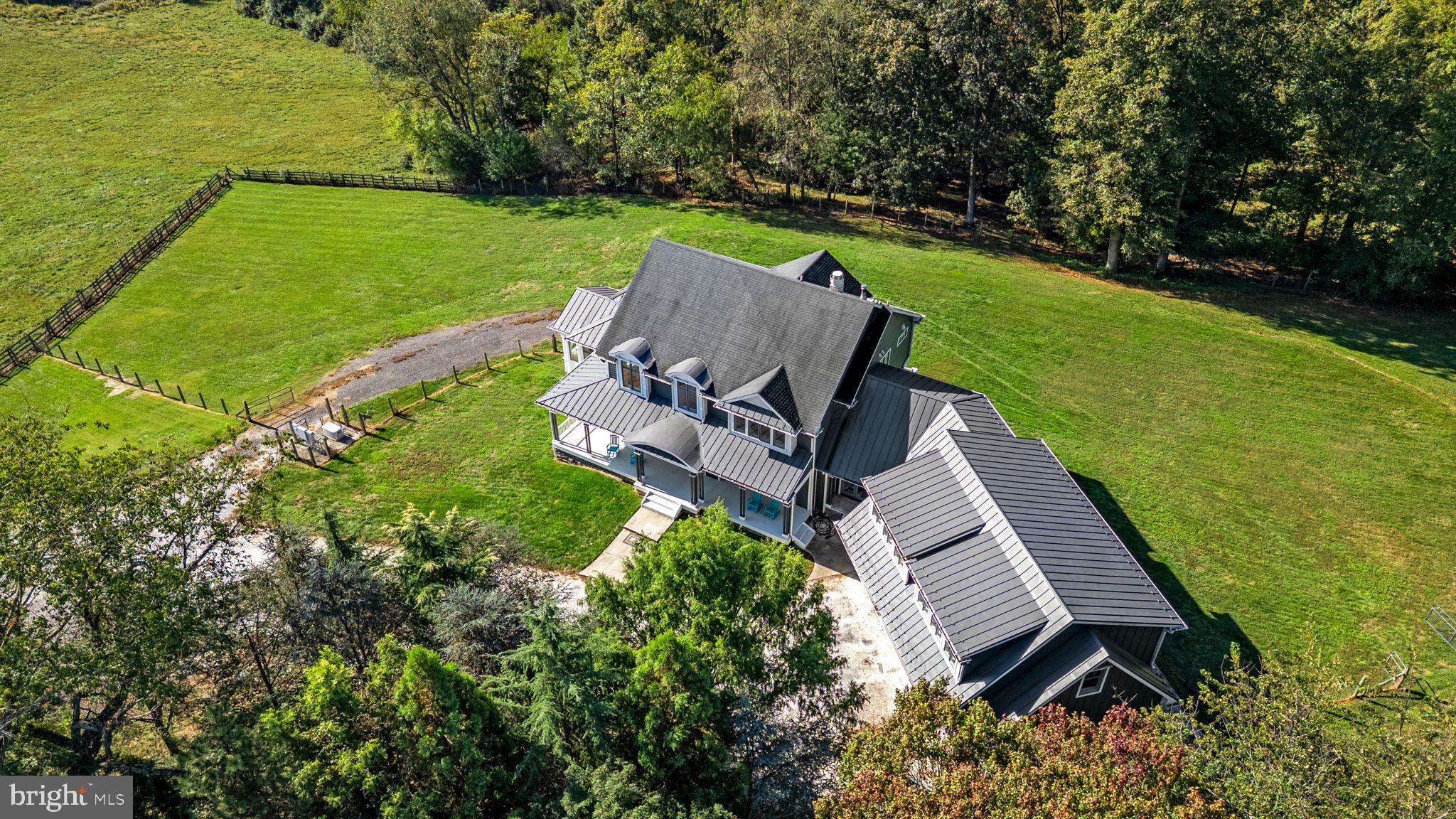 3216 Ramsland Way Frederick, MD 21704 - Photo 83 of 90 an aerial view of a house with a garden and lake view