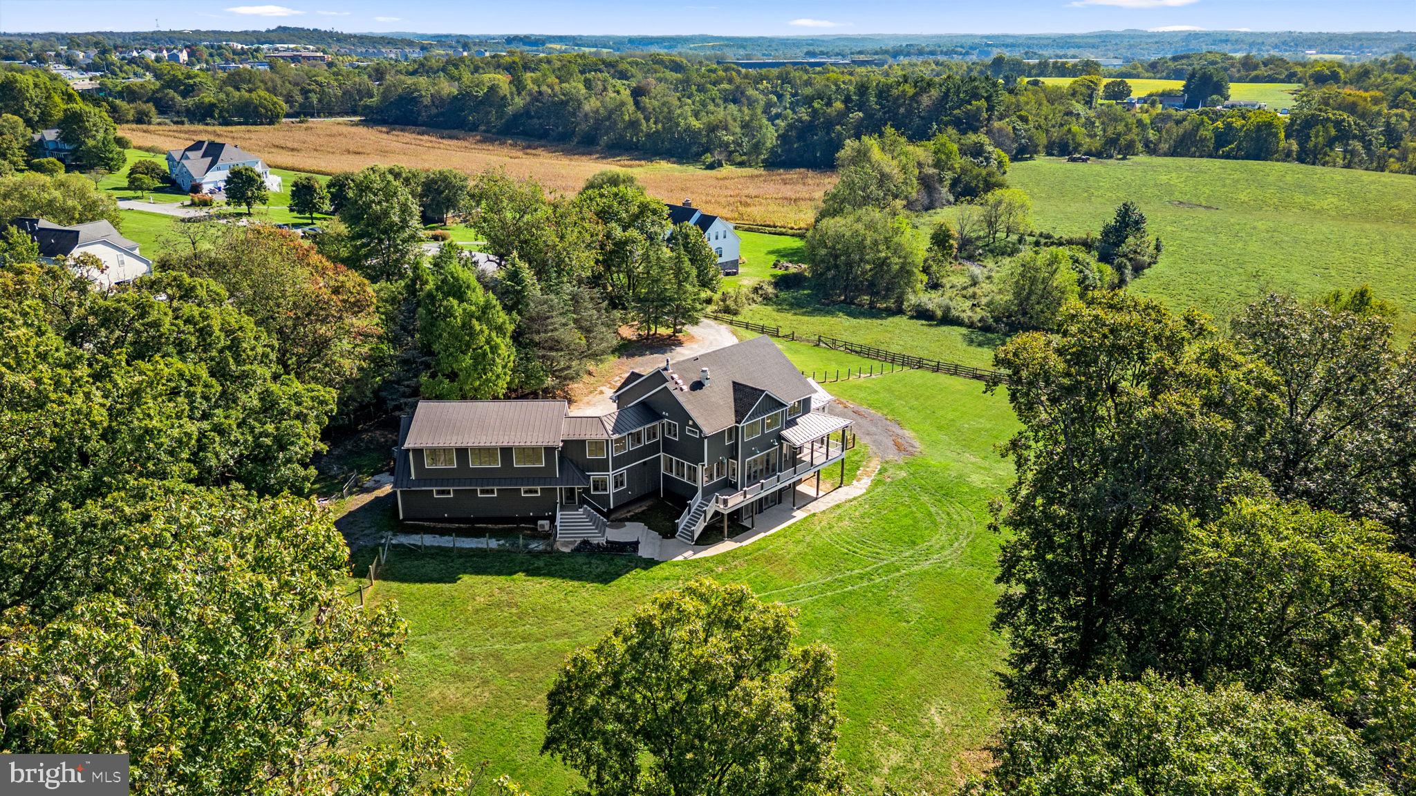 3216 Ramsland Way Frederick, MD 21704 - Photo 87 of 90 an aerial view of a house with a garden and lake view
