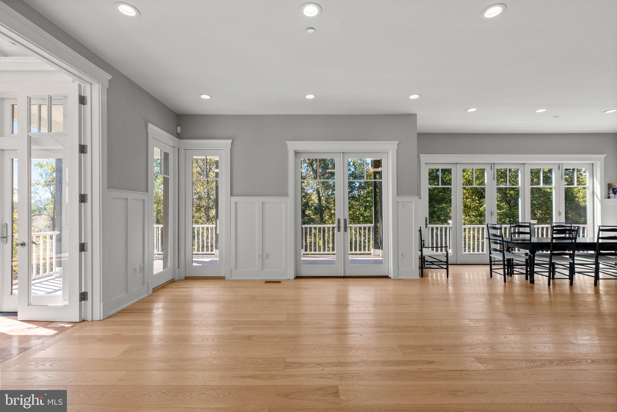 3216 Ramsland Way Frederick, MD 21704 - Photo 10 of 90 a view of empty room with wooden floor and floor to ceiling window
