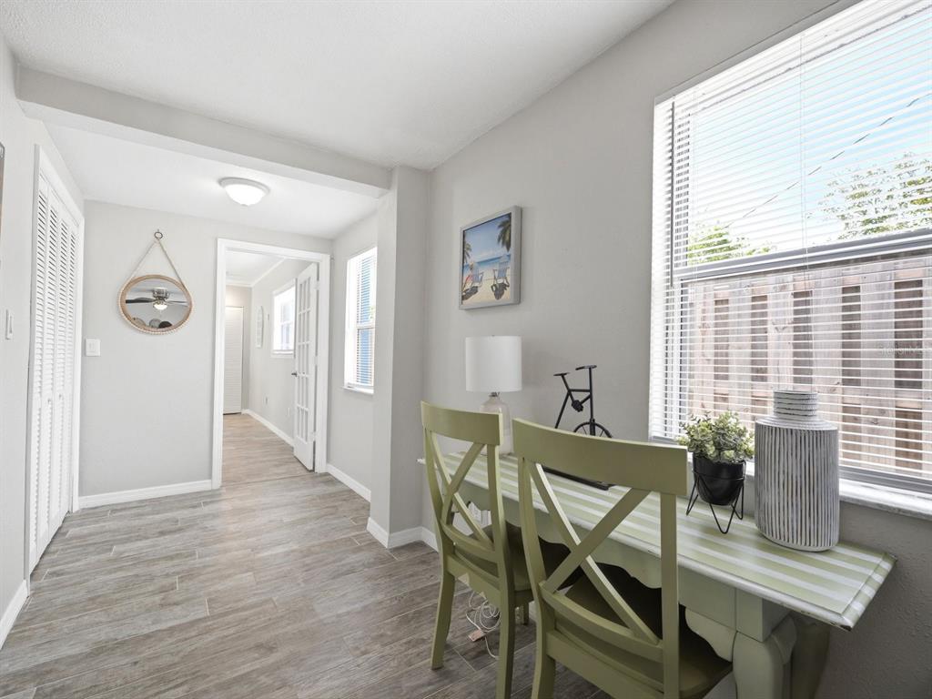 1207 1st Street Indian Rocks Beach, FL 33785 - Photo 16 of 60 a view of a dining room with furniture and wooden floor