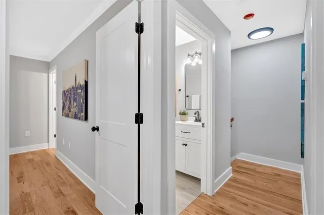 a view of a hallway with wooden floor and staircase