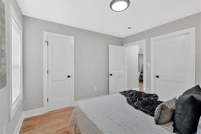 a bedroom with a bed and a window