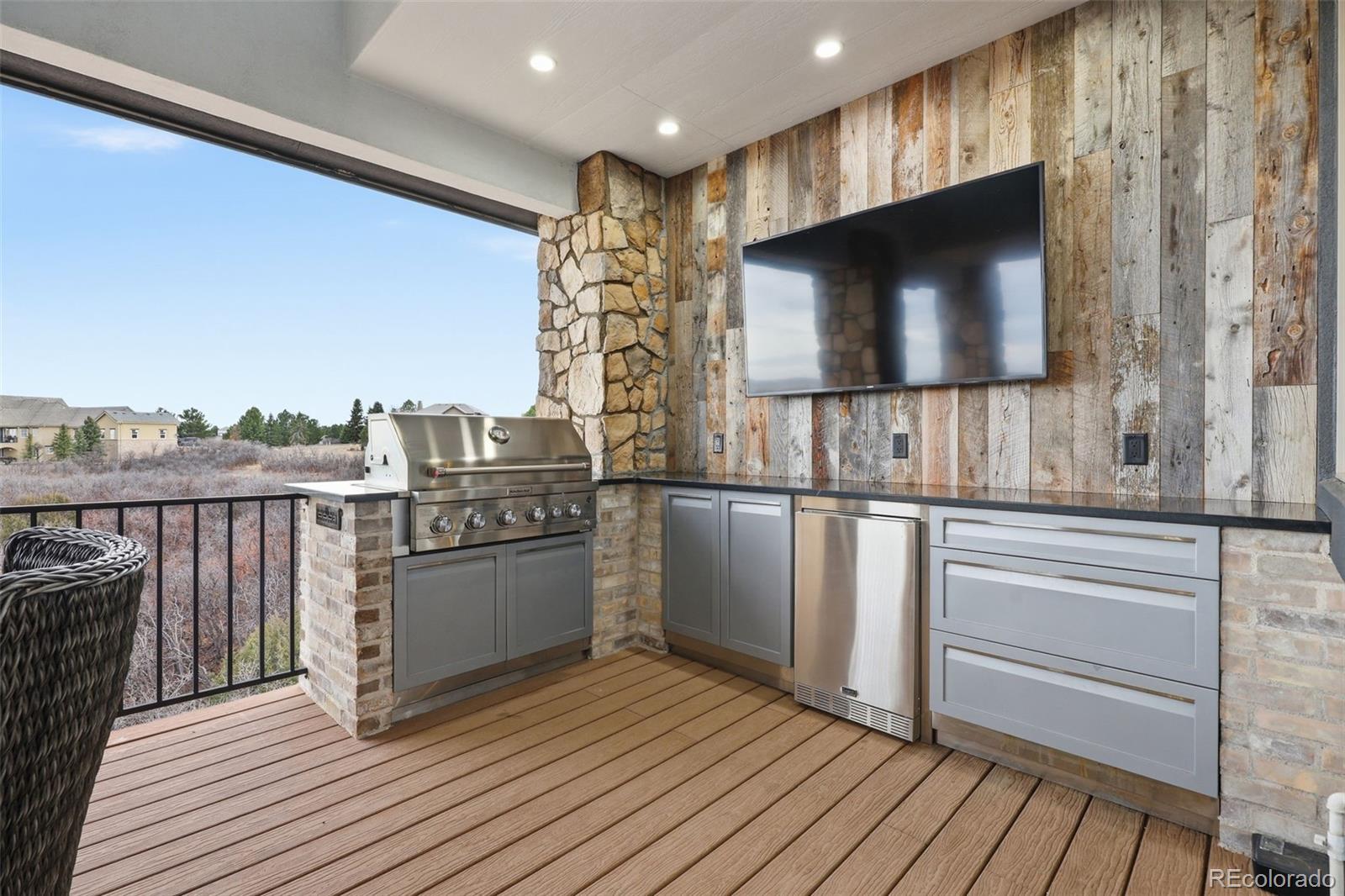 843 Diamond Ridge Circle Castle Rock, CO 80108 - Photo 15 of 31 a kitchen with stainless steel appliances wooden floor and a microwave