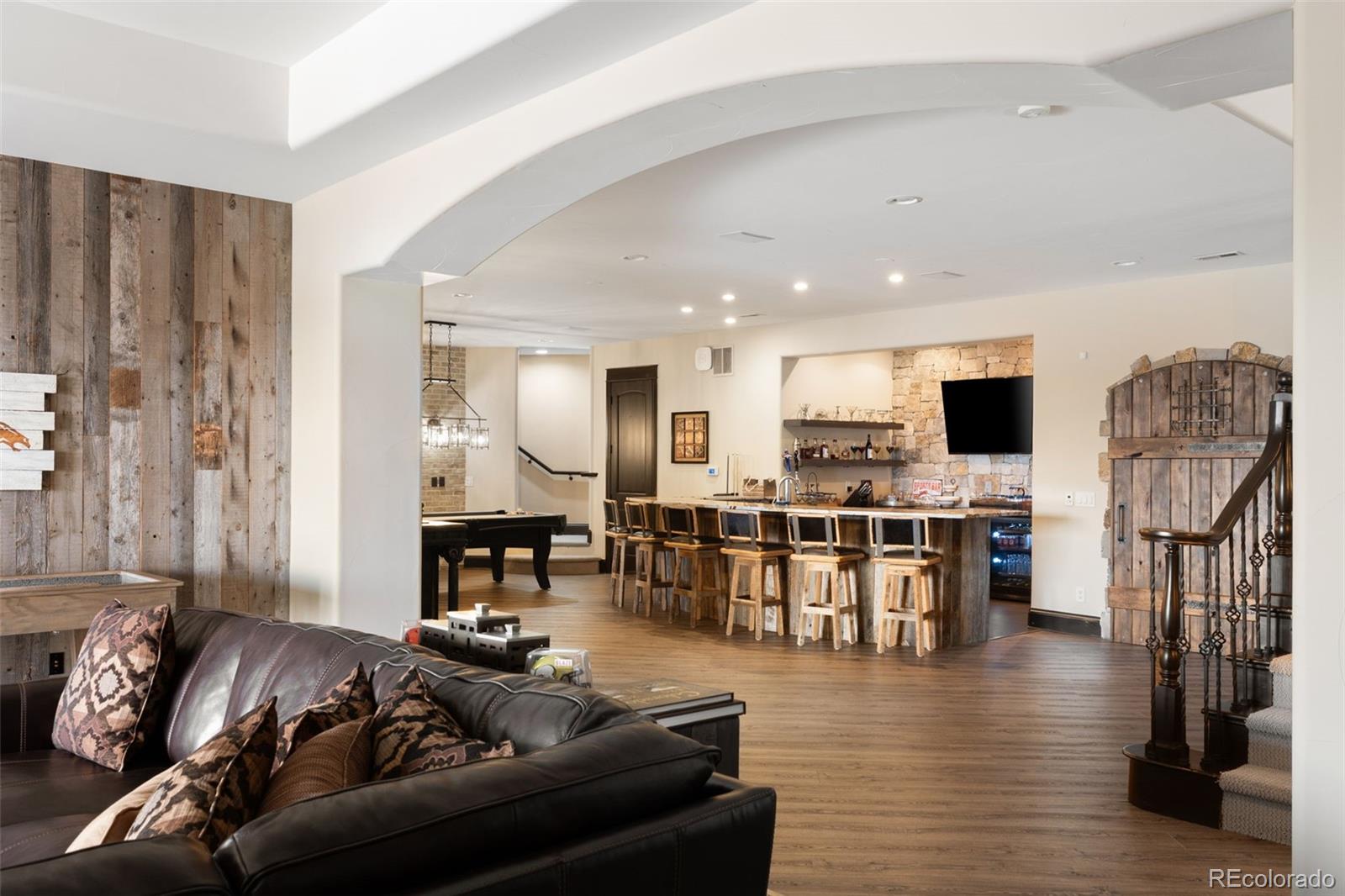 843 Diamond Ridge Circle Castle Rock, CO 80108 - Photo 22 of 31 a living room with furniture kitchen view and a flat screen tv