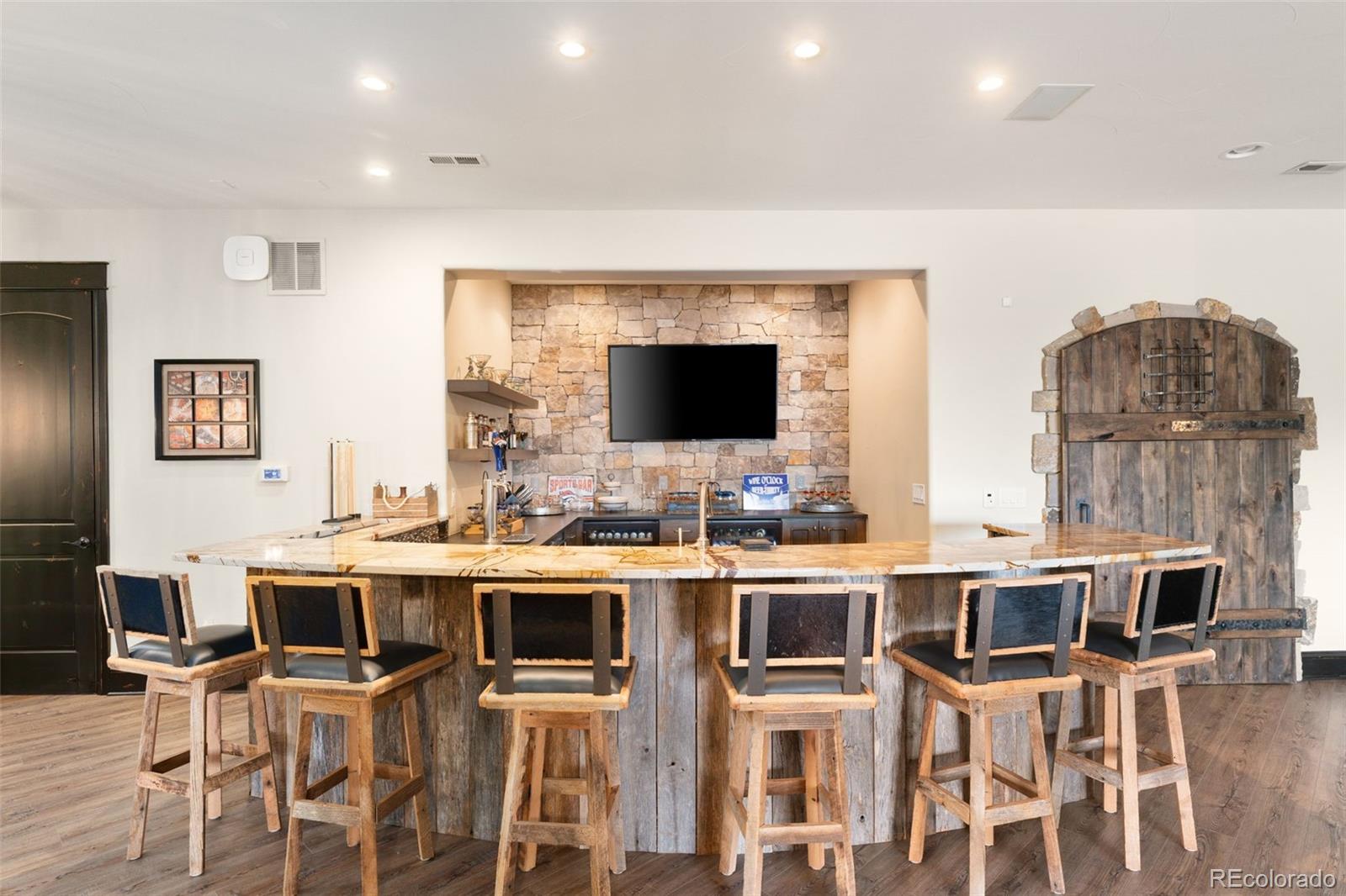 843 Diamond Ridge Circle Castle Rock, CO 80108 - Photo 24 of 31 a kitchen with a workspace and chairs