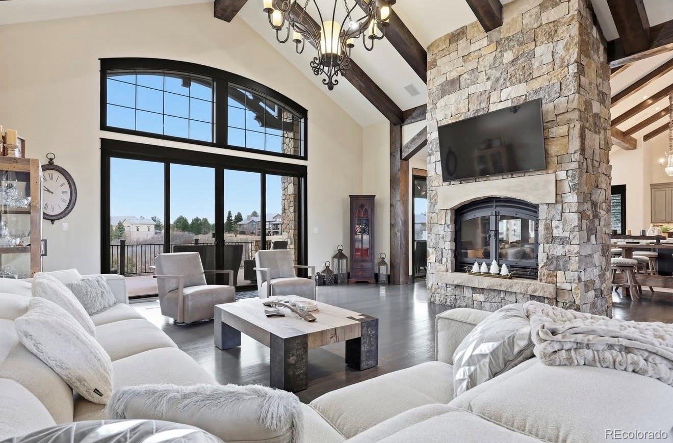 843 Diamond Ridge Circle Castle Rock, CO 80108 - Photo 5 of 31 a living room with furniture a fireplace and a flat screen tv