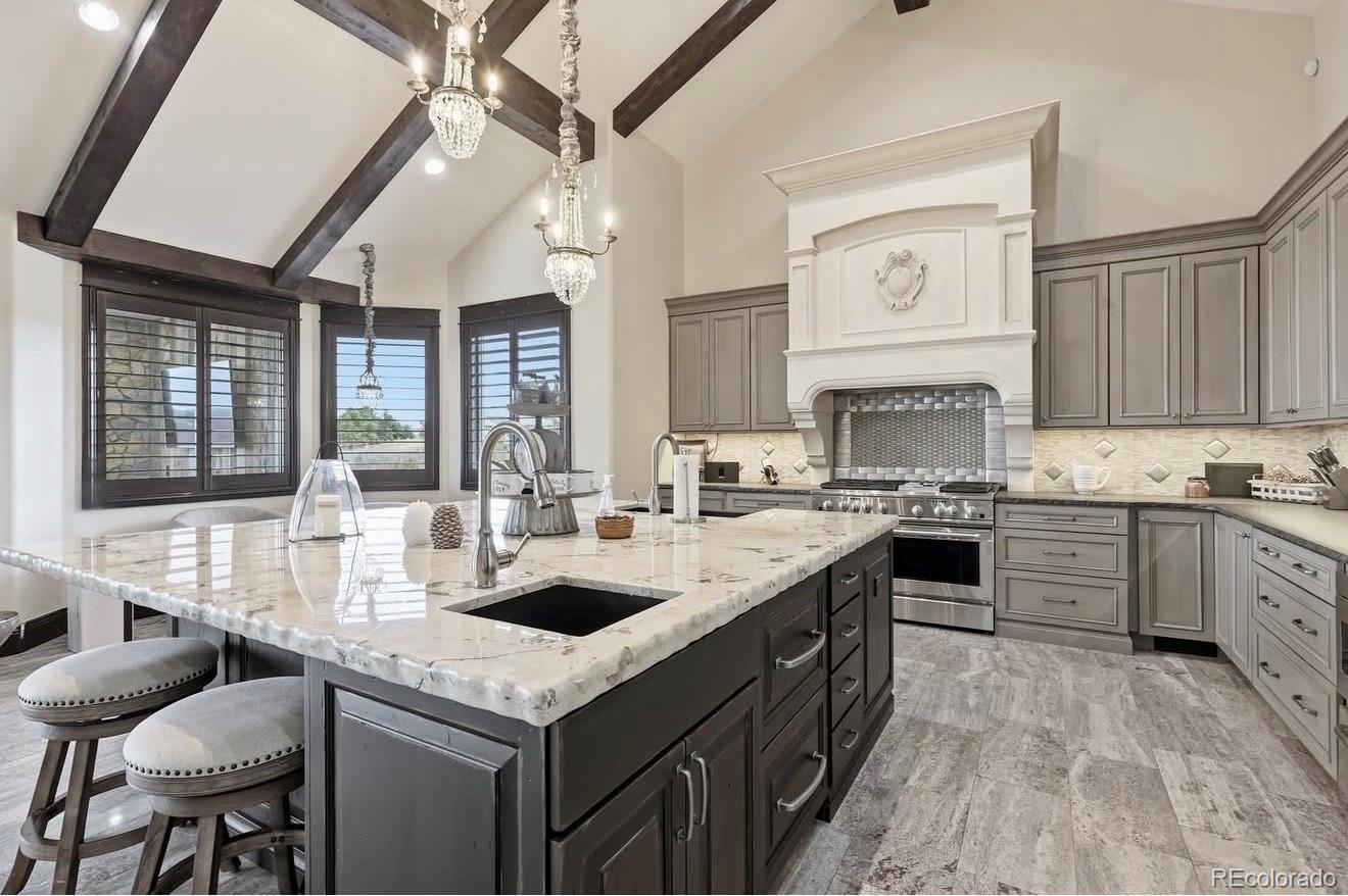 843 Diamond Ridge Circle Castle Rock, CO 80108 - Photo 8 of 31 a kitchen with granite countertop a sink stove and cabinets