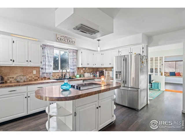 a kitchen with stainless steel appliances a refrigerator sink and cabinets