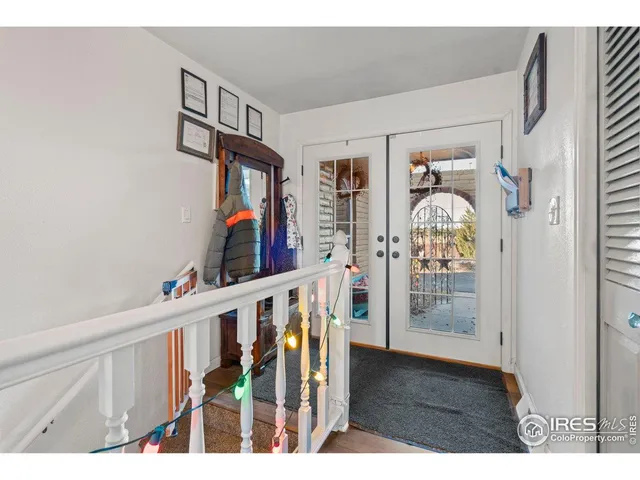 a view of an entryway and wooden floor