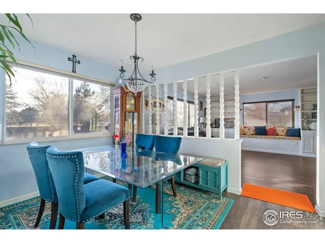 a dining room with furniture a chandelier and wooden floor