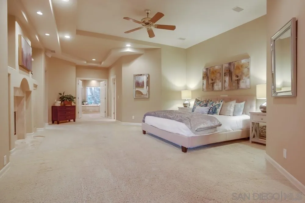 13409 Highlands Ranch Road Poway, CA 92064 - Photo 14 of 24 a spacious bedroom with a bed and ceiling fan