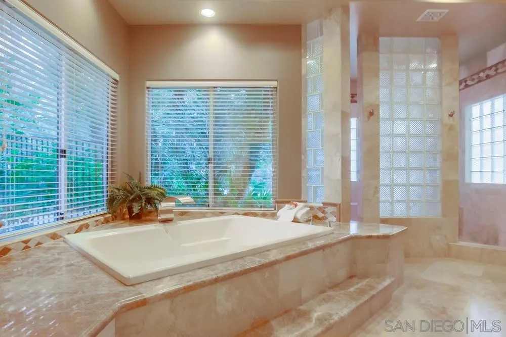 13409 Highlands Ranch Road Poway, CA 92064 - Photo 16 of 24 a bath tub sitting in a bathroom next to a window