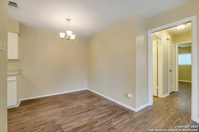 wooden floor in an empty room with a mirror