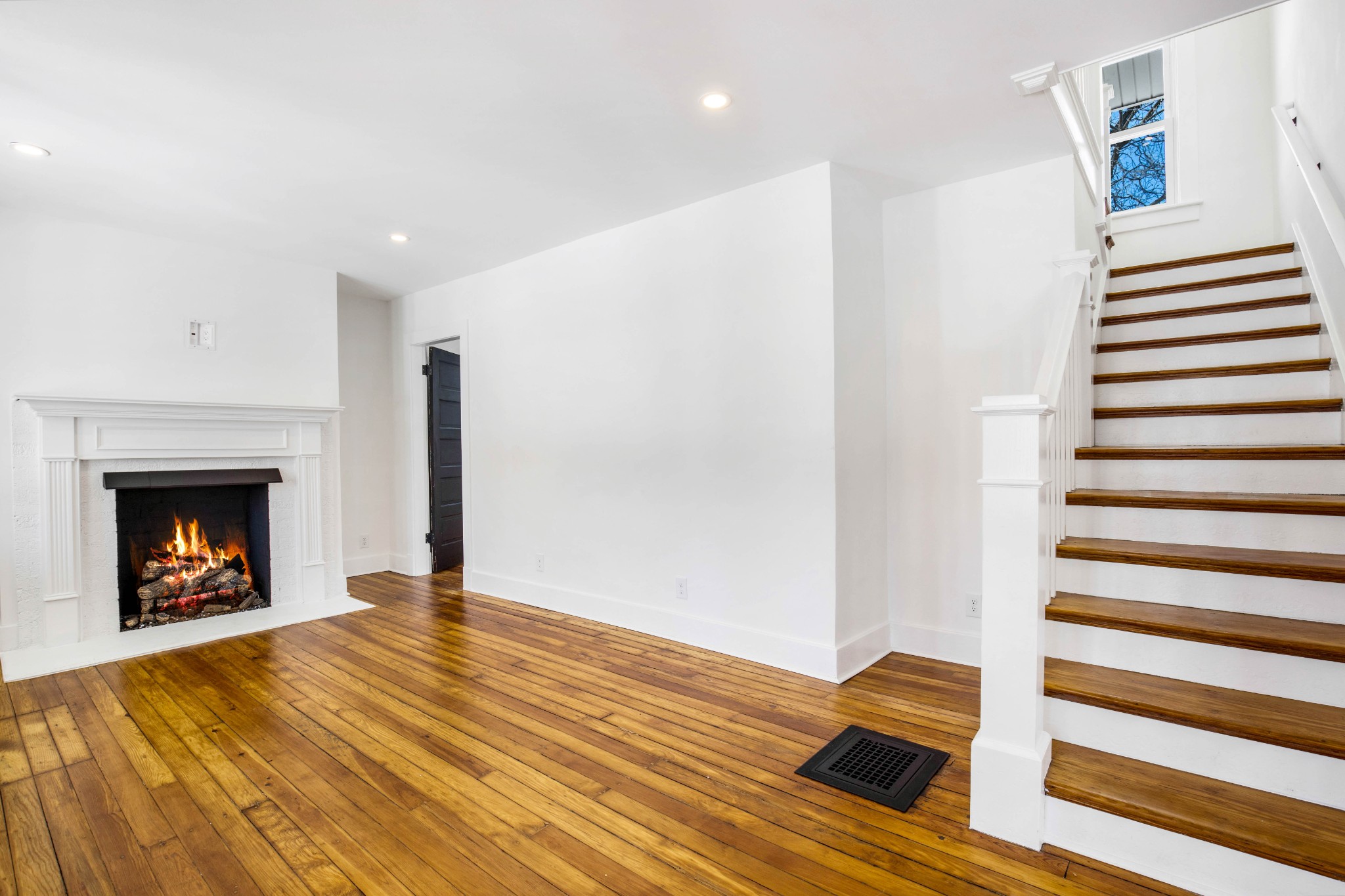 325 North Walnut Street Springfield, TN 37172 - Photo 11 of 34 a view of an empty room with wooden floor fire place and windows