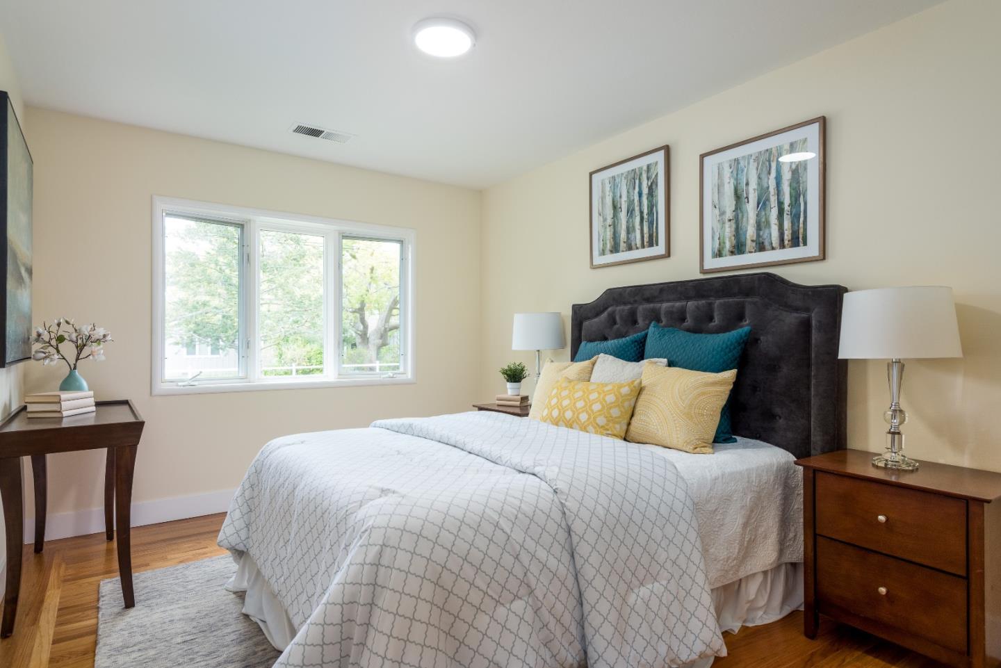 736 Filip Road Los Altos, CA 94024 - Photo 14 of 27 a bedroom with a bed a lamp and a window