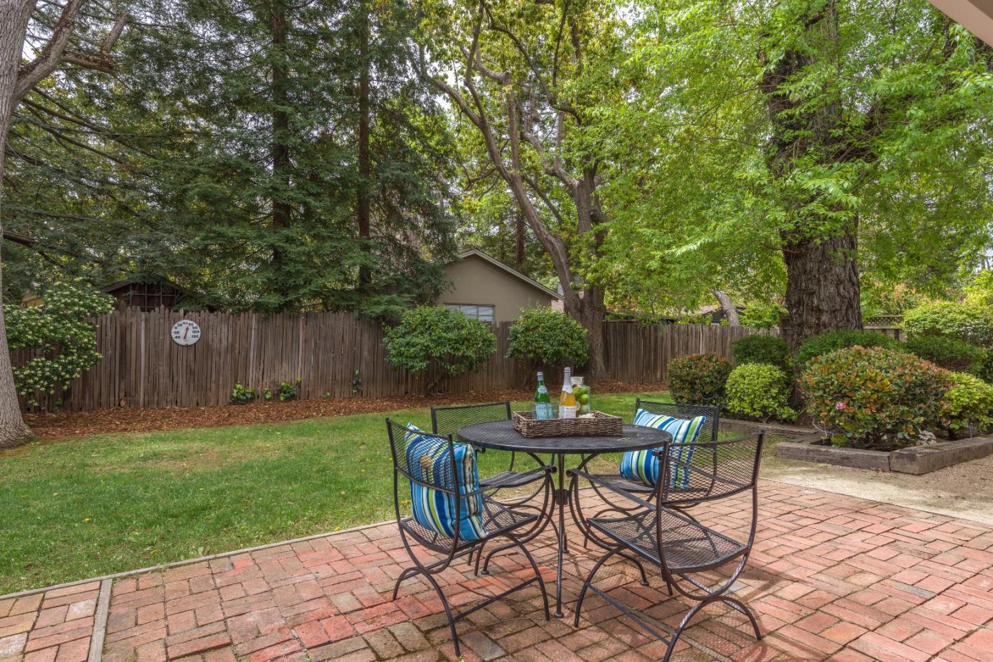 736 Filip Road Los Altos, CA 94024 - Photo 20 of 27 a view of a backyard with table and chairs and potted plants