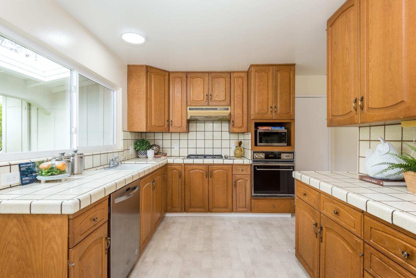 736 Filip Road Los Altos, CA 94024 - Photo 4 of 27 a kitchen with stainless steel appliances granite countertop a sink stove and refrigerator