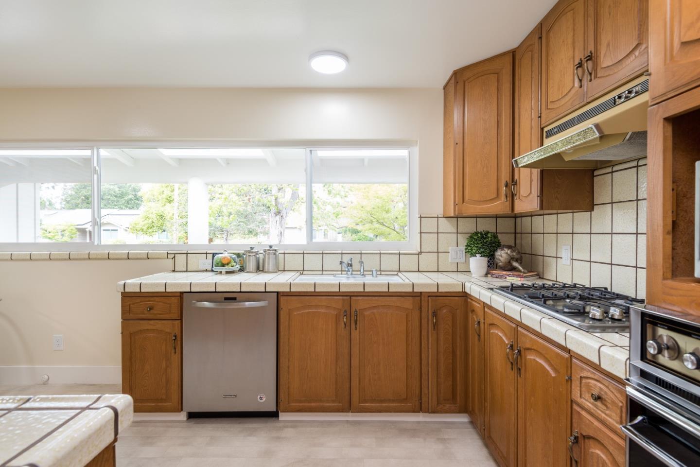 736 Filip Road Los Altos, CA 94024 - Photo 5 of 27 a kitchen with stainless steel appliances granite countertop a stove and a sink