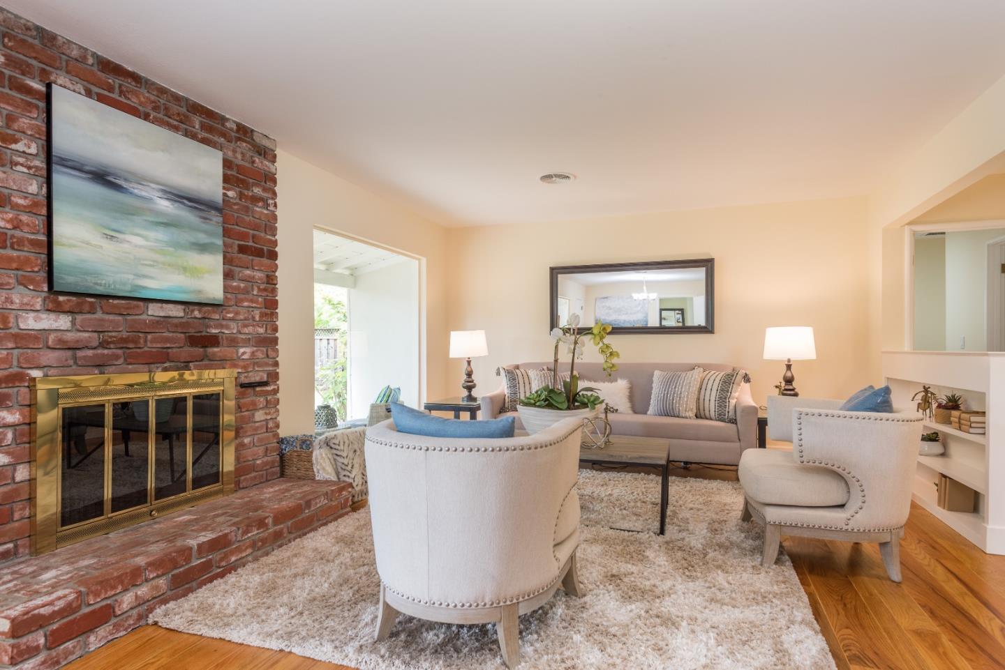 736 Filip Road Los Altos, CA 94024 - Photo 7 of 27 a living room with furniture a fireplace and a flat screen tv