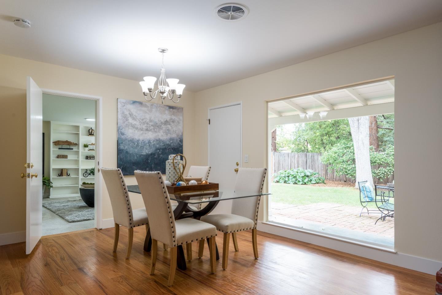 736 Filip Road Los Altos, CA 94024 - Photo 10 of 27 a dining room with furniture a chandelier and wooden floor