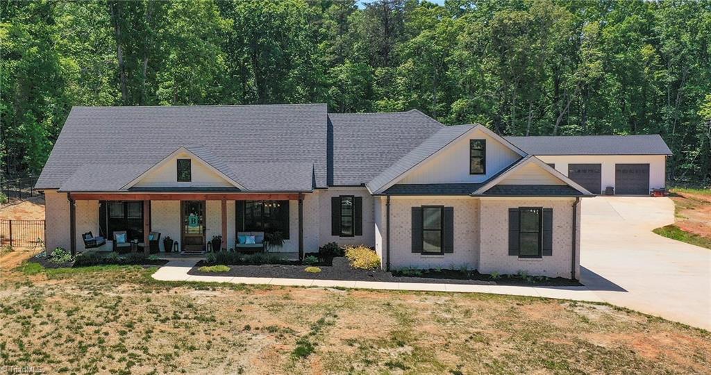 7988 Ridge Road Tobaccoville, NC 27050 - Photo 1 of 41 Front of home, with 4 bay detached garage in back