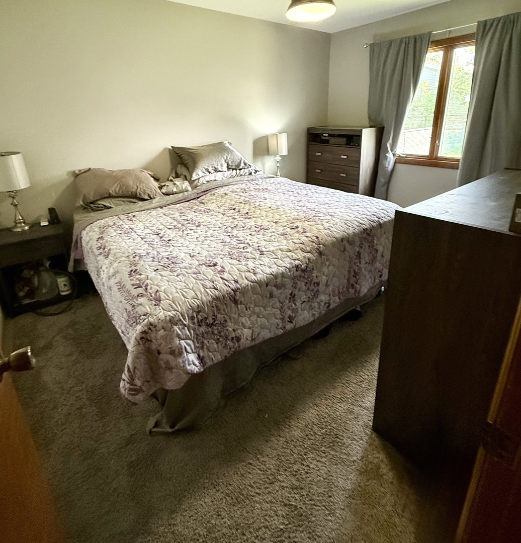5199 Elmwood Road Oak Forest, IL 60452 - Photo 16 of 30 a bed sitting in a bedroom next to a window