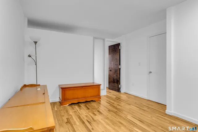 a view of a room with wooden floor and a sink