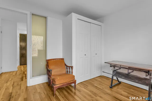 a blue chair sitting on top of a wooden floor