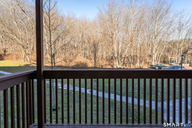 a view of a balcony with wooden fence and floor