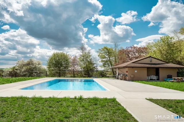 a view of a table and chairs under an umbrella