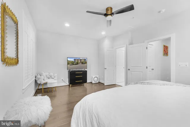 a spacious bedroom with a bed and a couch