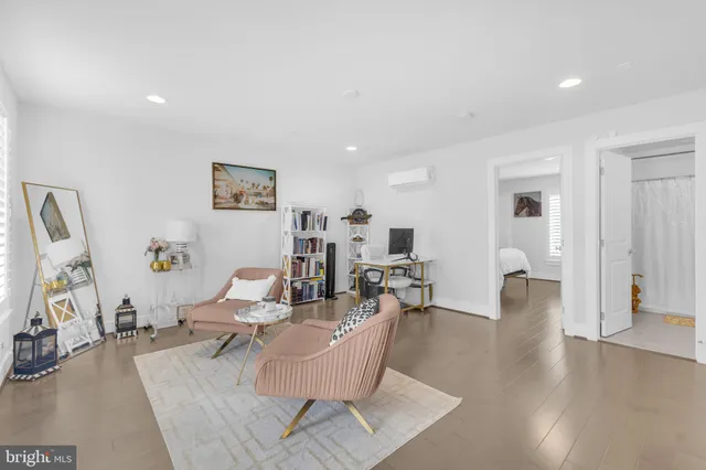 a living room with couches and a flat screen tv
